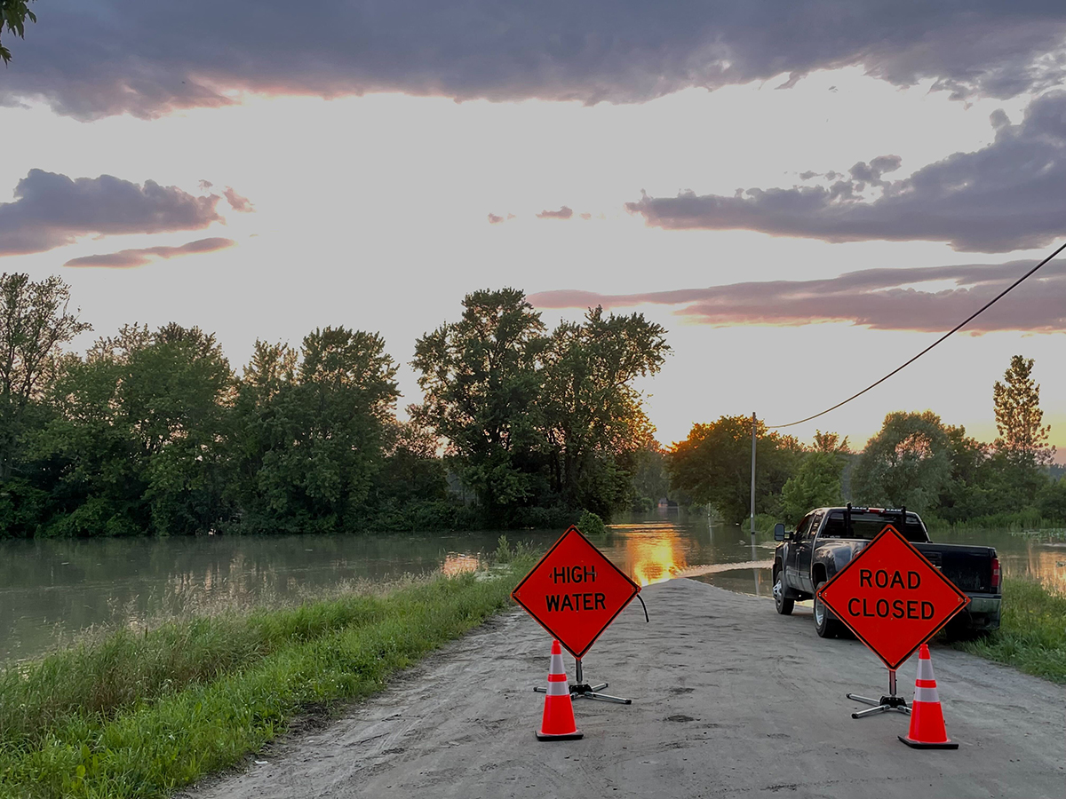 a truck is parked a road with cones in front of it.