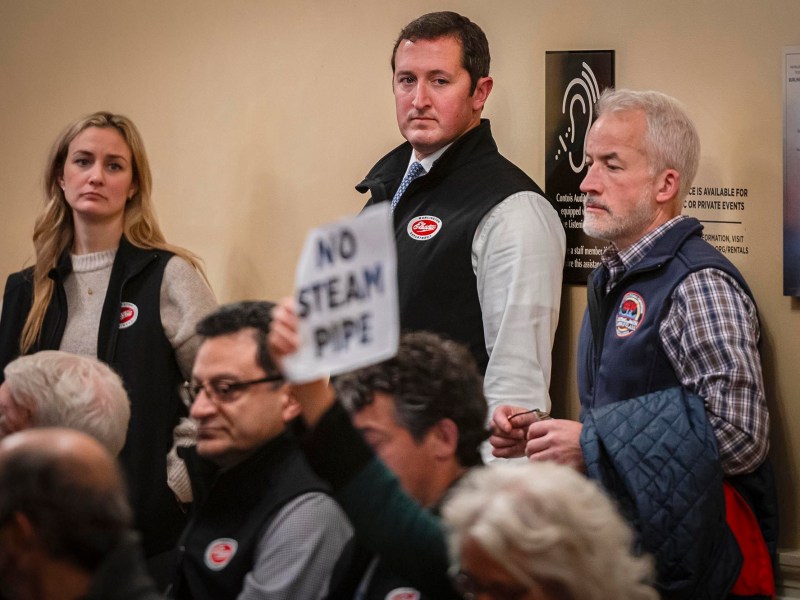A group of people holding signs in front of a room.