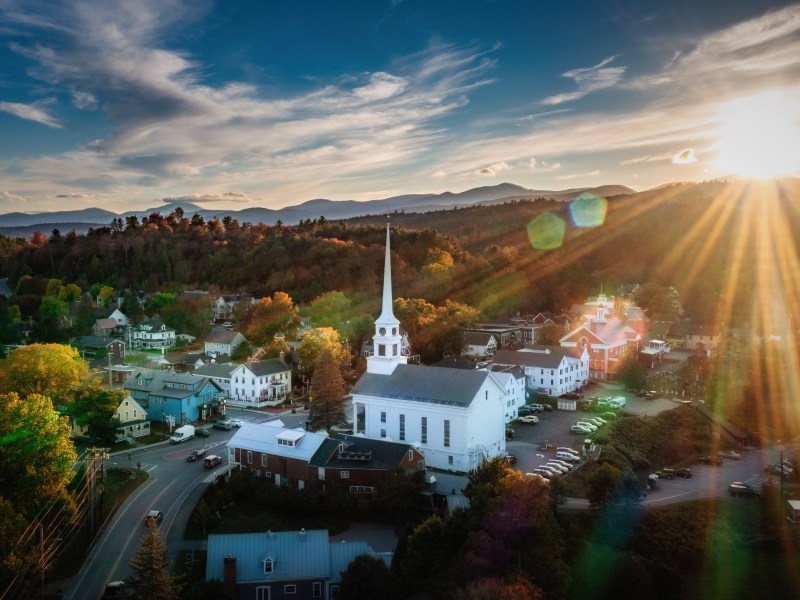 The sunset over a small Vermont town with a white church.