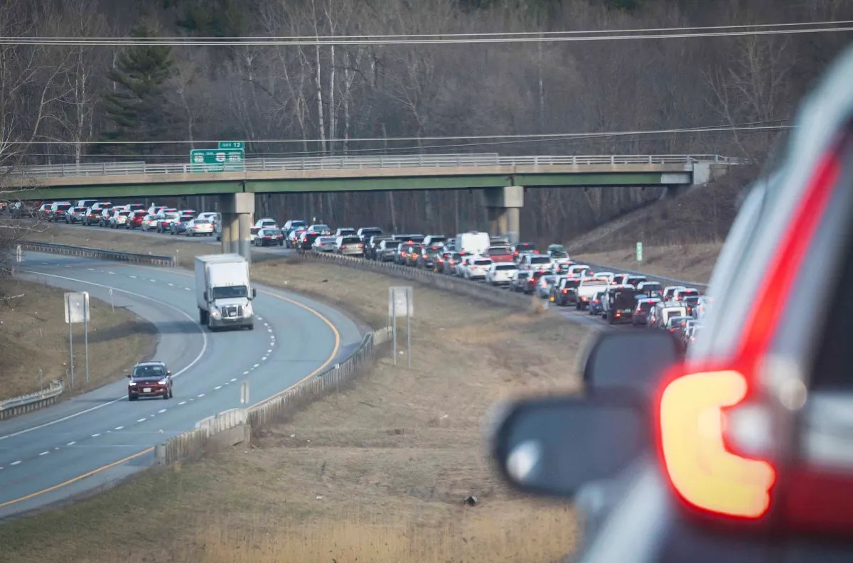 Heavy traffic congestion on the overpass as viewed from a car's perspective.