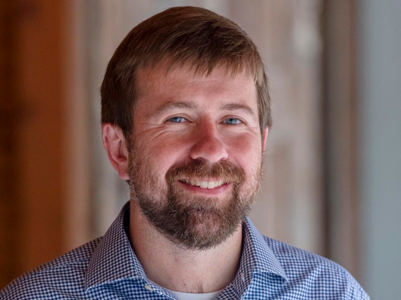 a close up of a person wearing a collared shirt.