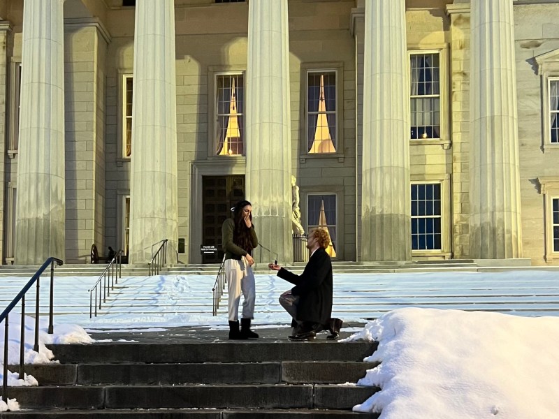 Two people in front of a building.